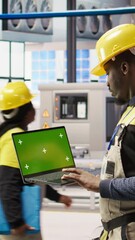Poster - vertical video solar panels factory engineer analyzes performance data with green screen laptop to p