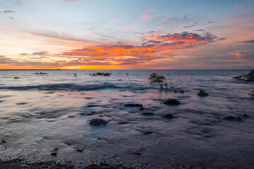 Wall Mural - rocky beach shore with beautiful sunset sky.