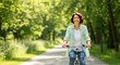 © rdkcho - Happy middle-aged woman enjoying a bike ride in a sunny park, healthy lifestyle and active retirement concept