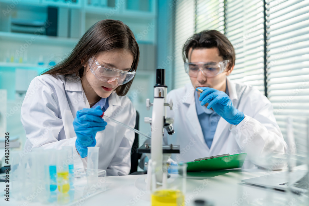 Asian male and female scientist work together in the research laboratory.