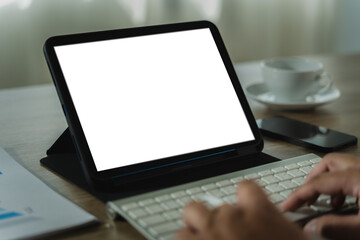 Poster - a businessman holds a mockup. ipad digital tablet with blank screen mockup replaces your design mock