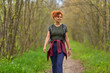 © Xalanx - Woman hiking on forest path
