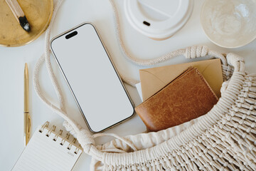 Wall Mural - Minimalist Composition with Notebook, Cotton Bag, and Smartphone in Warm Light