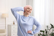© New Africa - Portrait of smiling woman with cancer in headscarf indoors