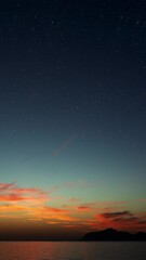 Wall Mural - sunrise over the sea with gentle waves and fading stars in a peaceful, dreamy atmosphere