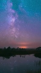 Wall Mural - Lake Nature Landscape. Night Starry Sky Milky Way Galaxy With Glowing Stars. Time Lapse Time-Lapse Nature Hyperlapse. Night Sky Reflection In Water