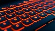 © Pragmatic Earth - Close-up view of a luminous computer keyboard with orange backlit keys against a dark background for technology themed designs.
