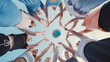 © Довидович Михаил - School friends reaching for a globe against a blue sky, representing global unity, environmental awareness, and international collaboration