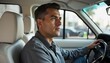 © Shams - Handsome Mature Man Driving Car Looking Ahead Confidently On Sunny Day