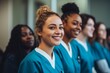 © Baba Images - diverse group of smiling female nurses at training at college