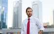 © Minerva Studio - Businessman looking away posing in the financial district