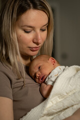 Aufkleber - Loving mother holds her newborn baby close during a quiet moment at home in warm evening light