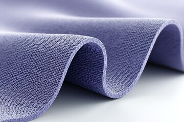 Poster - Soft purple fabric gently draped on a smooth surface in a well-lit room showcasing texture and color