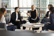 © fizkes - Group education. Middle aged woman professor teacher coach hold learning event training seminar workshop for diverse multiethnic student team at cozy modern meeting room give knowledge lead discussion
