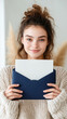 © Ruzana - Young caucasian female holding blue envelope with white paper and a smile
