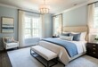© Daniel - A bedroom with a large bed and a white chair.