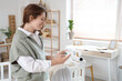 © Pixel-Shot - Young woman with baby monitor in children's bedroom