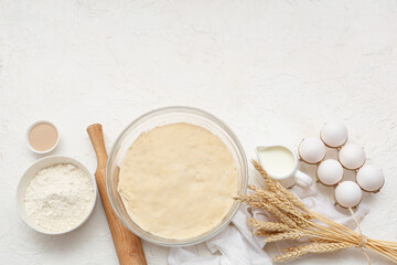 Wall Mural - composition with wooden rolling pin, dough and ingredients on white background