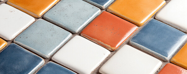 Poster - A tile floor with a variety of colors including blue, white, and orange. The tiles are arranged in a checkered pattern