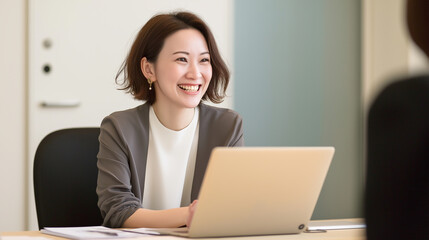 Poster - Young businesswoman smiling and working on laptop in office meeting