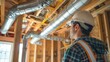 © Dara - A contractor overseeing the installation of HVAC ductwork in a home.