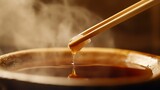 Pouring hot, brown coffee, a flavorful beverage, into a white cup
