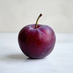 Poster - Single fresh plum with stem on bright surface showcases fruit's smooth, deep purple skin, and healthy, natural aesthetic