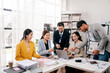 © Dino - Brainstorming of young modern group. Team meeting to achieve goal. Business people discussing finance business and analysis. Teamwork concept in modern office. Calculating personal tax for client.