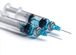 © Bartek - Close-up of Two Hypodermic Syringes With Blue Liquid on White Background for Medical and Pharmaceutical Use