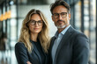 © Ahapen - Two executive managers at office. Portrait of successful business people in formal wear, confident corporate employees standing together in modern workplace. vsai