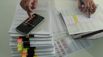 Poster - businessman uses a calculator and paperwork to analyze finances, investments, and tax reports at his desk calculator and digital tablet. business financial reports and data analysis				