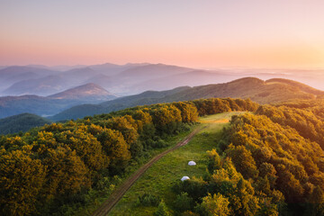 Poster - Mountain range in the evening light with tourist tents in the camp. Carpathian mountains, Ukraine, Europe.