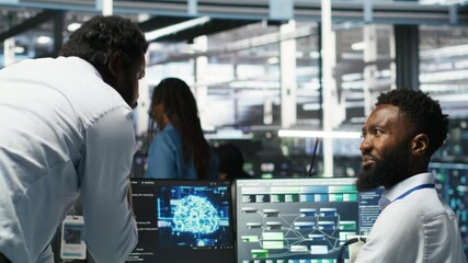 Poster - Pleased data center manager praising work done by engineer using neural network models to configure hardware. Supervisor congratulating employee for successfully using AI to optimize system, camera B