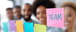 © praewpailyn - Team collaboration with colorful sticky notes showcasing teamwork energy and creativity in modern workspace