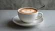 © ArtificialHorizons - Elegant white ceramic mug filled with steaming cappuccino topped with cream milk foam and a spoon.