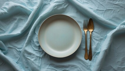 Poster - Overhead flat lay of an empty white plate with a fork and knife, representing dinner setting