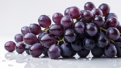 Poster - Isolated bunch of ripe purple grapes with water drops on white background