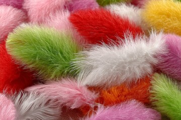 Poster - Colorful fuzzy pom poms scattered on a flat surface showcasing vibrant hues in a playful arrangement