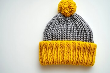 Poster - Warm knitted beanie with yellow pom-pom and gray body, perfect for winter activities and outdoor adventures