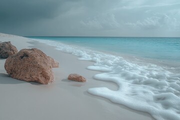 Aufkleber - Calm shoreline with gentle waves and rocks under cloudy sky at tranquil beach location
