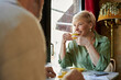 © LIGHTFIELD STUDIOS - Cherished moments over coffee between a mature couple in a cozy cafe
