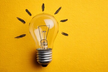 Aufkleber - Creative light bulb concept against a bright yellow background highlighting innovation and ideas