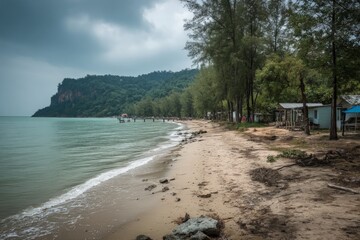 Aufkleber - Calm beach shore with wooden pier and lush hillside under cloudy sky in tropical location