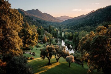 Poster - Serenity in a lush valley with mountains and a winding river at sunset