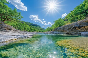 Poster - Clear turquoise water reflects sunlight under bright blue sky in a serene river landscape during midday in a lush natural setting