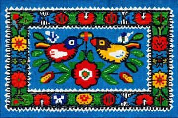 Poster - Colorful textile showcasing vibrant birds and floral patterns with intricate designs