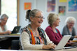 © Artinun - Tech savvy seniors participating in digital learning workshop using tablets at community center showcasing collaborative skill development and cheerful group education for mature active lifestyle
