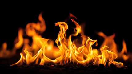 Wall Mural - Fiery orange and yellow flames dance against a stark black background, creating a dramatic and intense image.