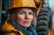 © vasyl pshyk - Empowered woman in hard hat embraces challenges of heavy machinery in an industrial environment