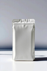 Aufkleber - Silver pouch stands on white surface. Clean empty packaging. Simple design for food or other products. Minimal style with light and shadows. Room for your ideas. Metal bag.